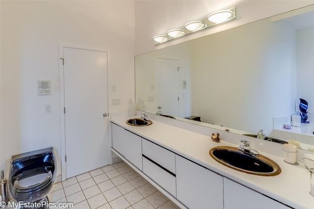 bathroom with tile patterned flooring and vanity