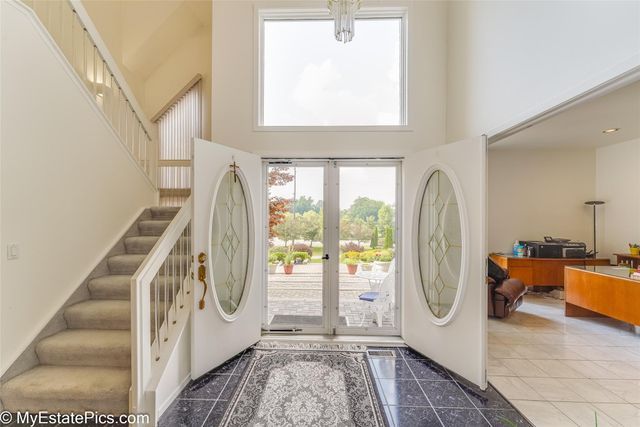 entrance foyer with tile patterned flooring and a high ceiling