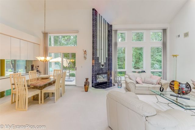 living room with a tile fireplace and carpet