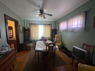 dining room featuring ceiling fan and wood-type flooring