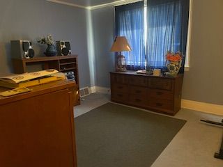 carpeted bedroom featuring crown molding