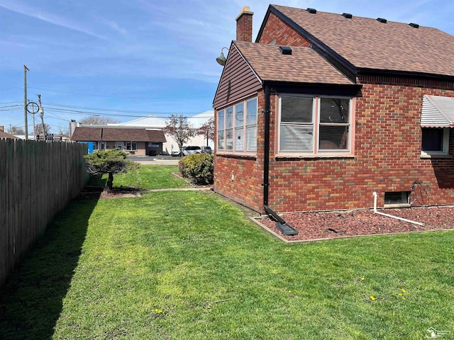 view of home's exterior with a yard