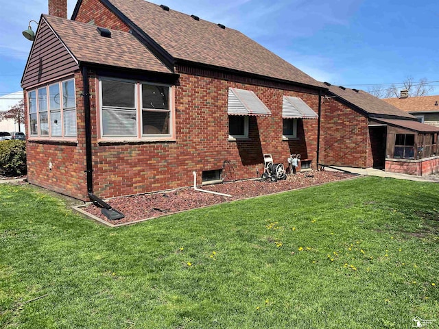 rear view of house with a yard