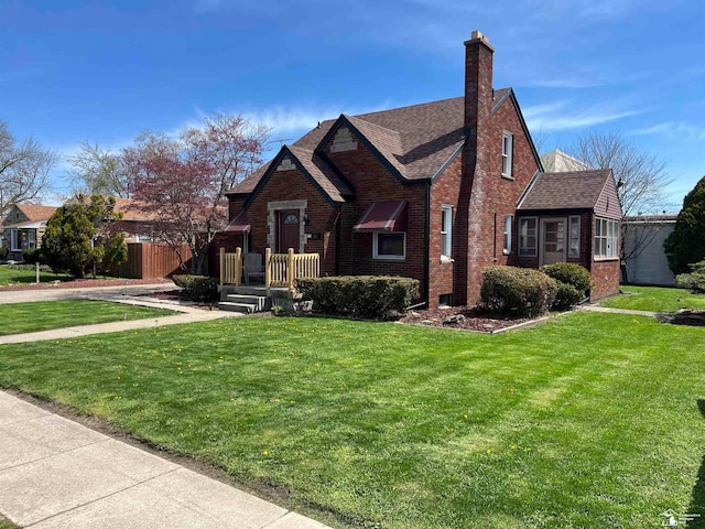 tudor-style house featuring a front lawn