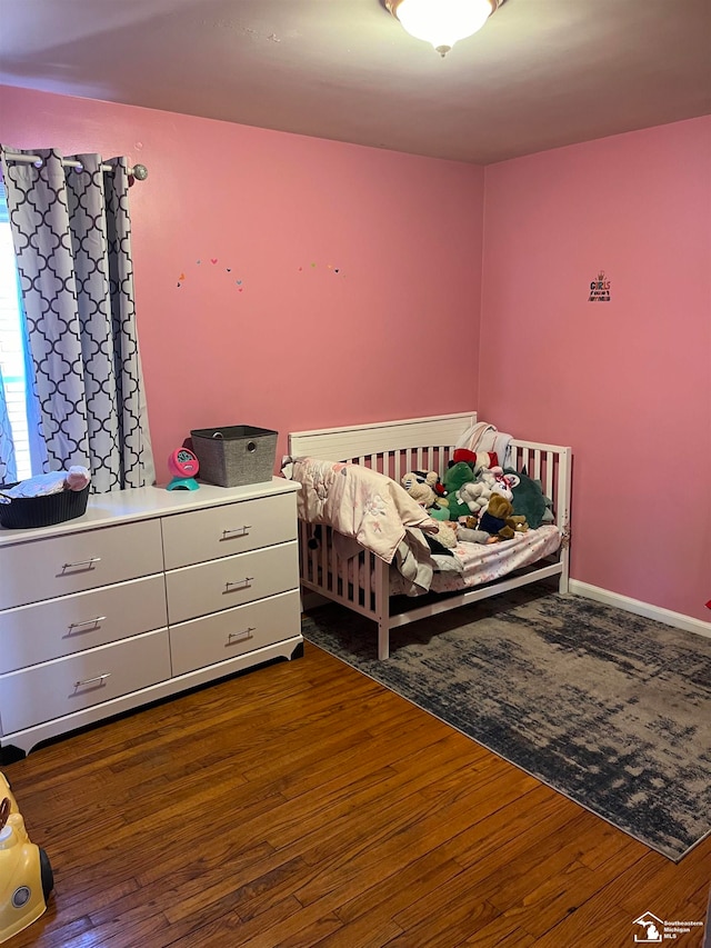 bedroom with dark hardwood / wood-style floors