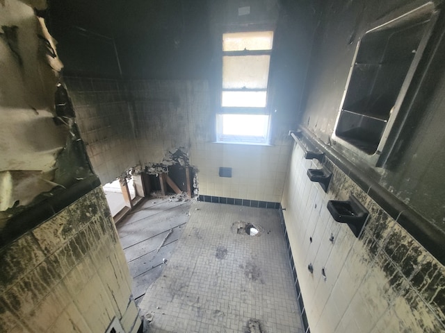 bathroom with tile walls