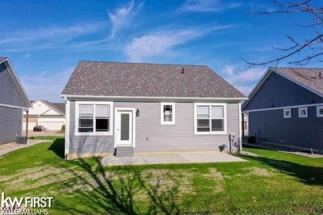 rear view of property featuring a patio area and a yard