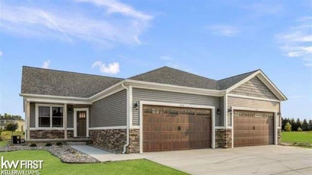 view of front of property featuring a garage and a front yard