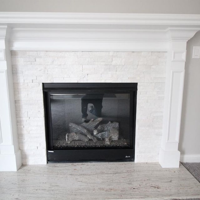 details with crown molding and a fireplace