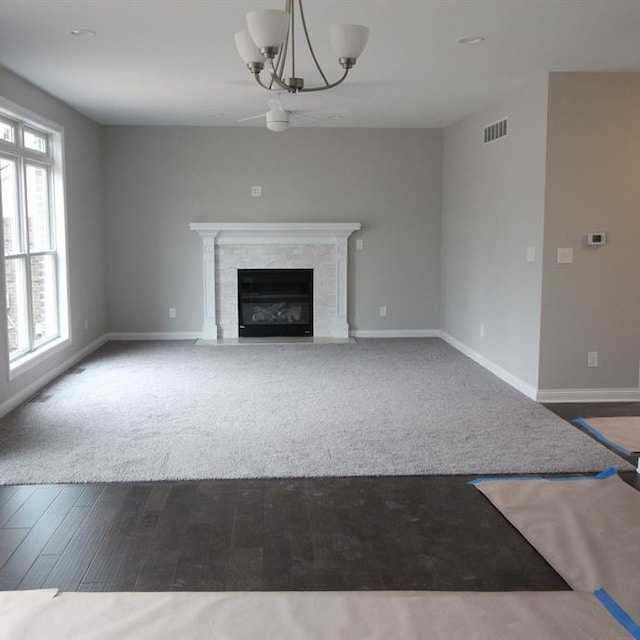 33690 N Bostwick, Farmington Hills, MI 48335 - unfurnished living room featuring baseboards, a chandelier, a high end fireplace, and wood finished floors