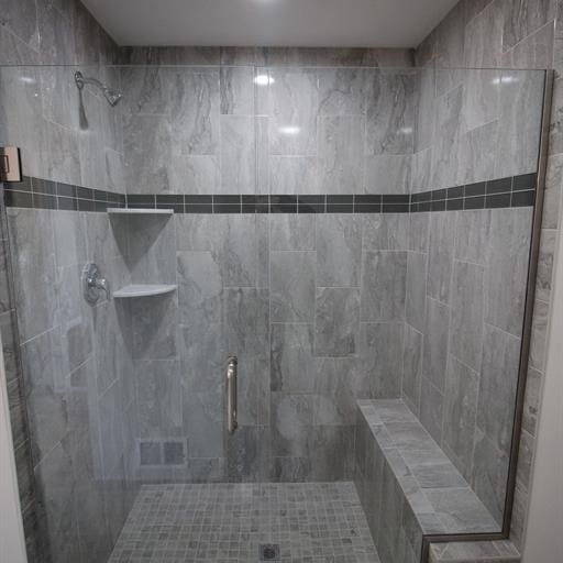 bathroom with a shower with door