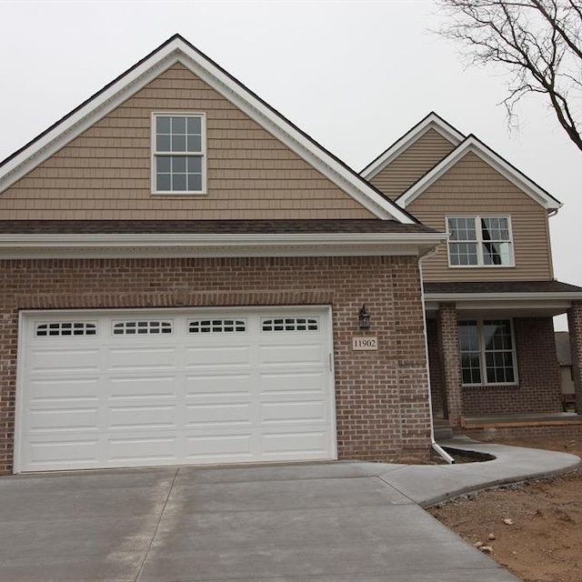 view of front facade with covered porch and a garage