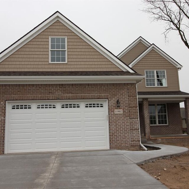 33690 N Bostwick, Farmington Hills, MI 48335 - view of front of home featuring driveway and brick siding