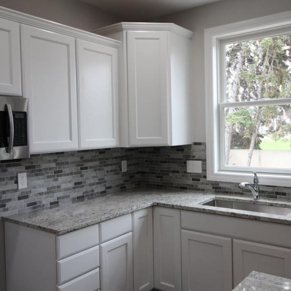 33690 N Bostwick, Farmington Hills, MI 48335 - kitchen with stainless steel microwave, a sink, tasteful backsplash, and white cabinetry