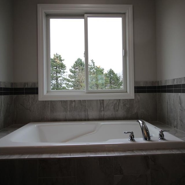 bathroom featuring tiled bath