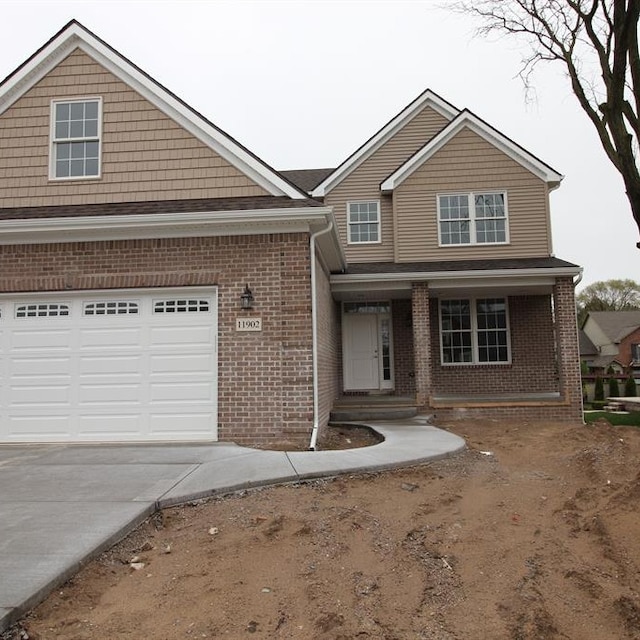 33690 N Bostwick, Farmington Hills, MI 48335 - view of front of property with concrete driveway, brick siding, an attached garage, and a porch