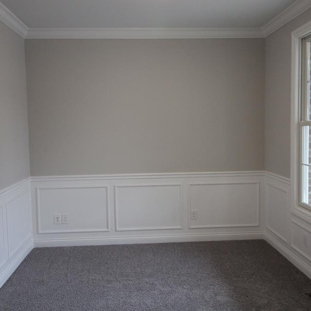 spare room with crown molding and dark carpet