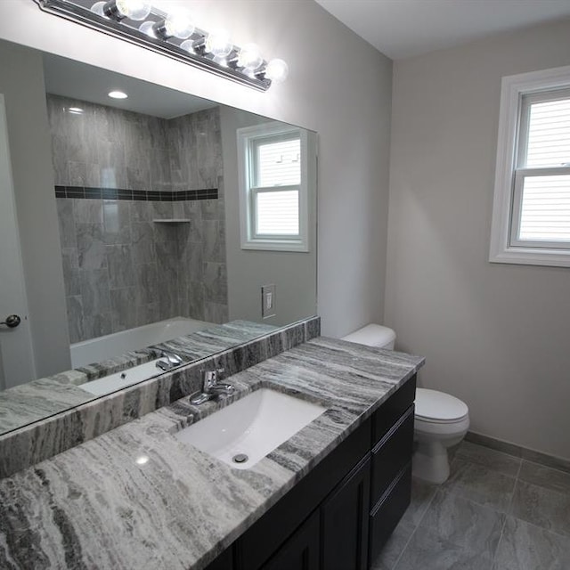 full bathroom featuring vanity, toilet, and tiled shower / bath