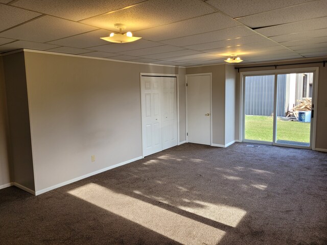 1299 Sand Beach Rd, Bad Axe, MI 48413 - unfurnished room featuring dark colored carpet, a paneled ceiling, and baseboards