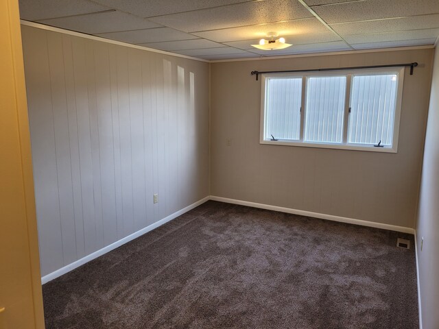 1299 Sand Beach Rd, Bad Axe, MI 48413 - spare room featuring dark colored carpet, a drop ceiling, and baseboards