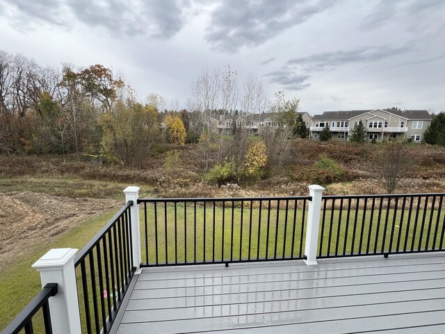 wooden deck with a lawn