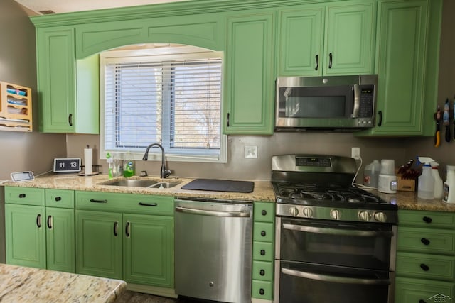 kitchen with light stone counters, sink, and appliances with stainless steel finishes