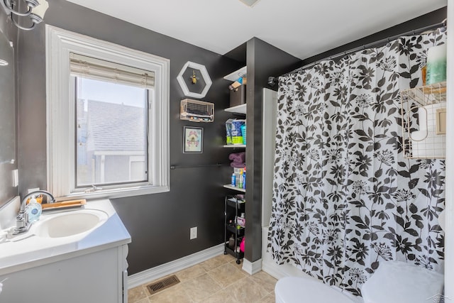 bathroom with walk in shower, tile patterned flooring, vanity, and toilet