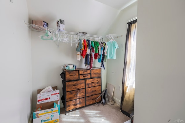 spacious closet featuring carpet floors and lofted ceiling