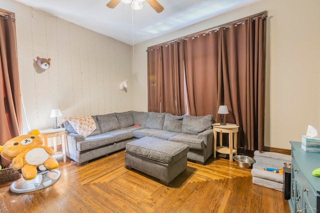 living room featuring ceiling fan and hardwood / wood-style flooring