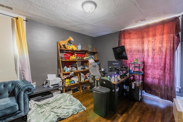 office with a textured ceiling and dark hardwood / wood-style flooring