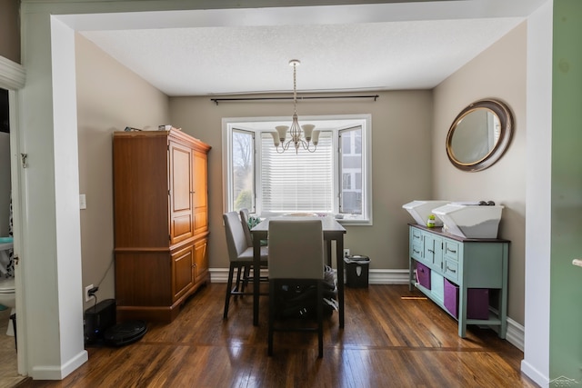 dining room featuring a notable chandelier and dark wood-type flooring