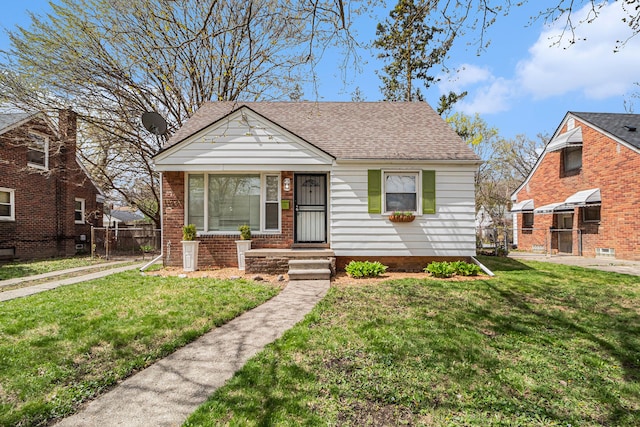 bungalow-style home featuring a front lawn