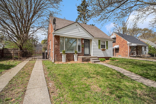 bungalow-style home with a front yard