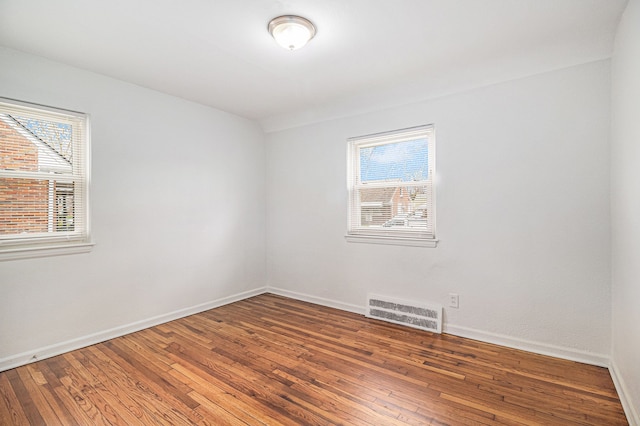 unfurnished room with hardwood / wood-style floors