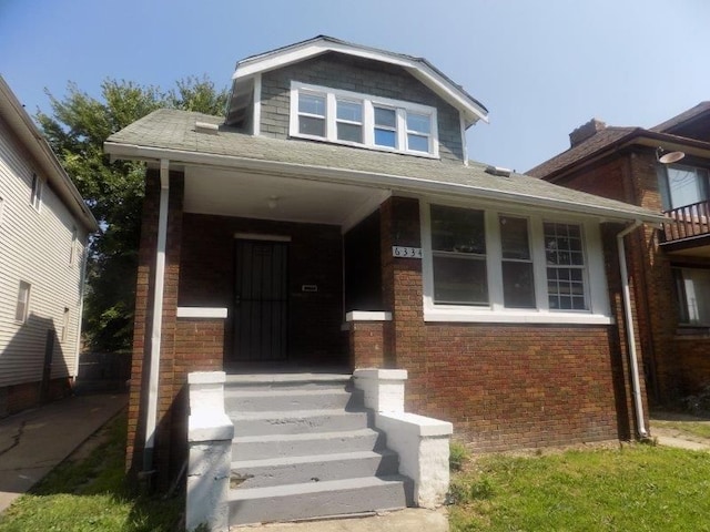 6334 Tuxedo Ave, Detroit, MI 48204 - view of front of property with brick siding, roof with shingles, and covered porch