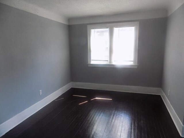 6334 Tuxedo Ave, Detroit, MI 48204 - empty room featuring dark wood finished floors and baseboards