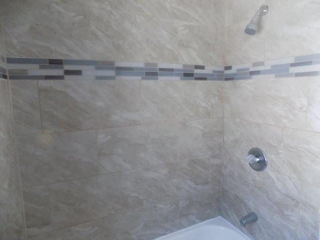 interior details featuring tiled shower / bath