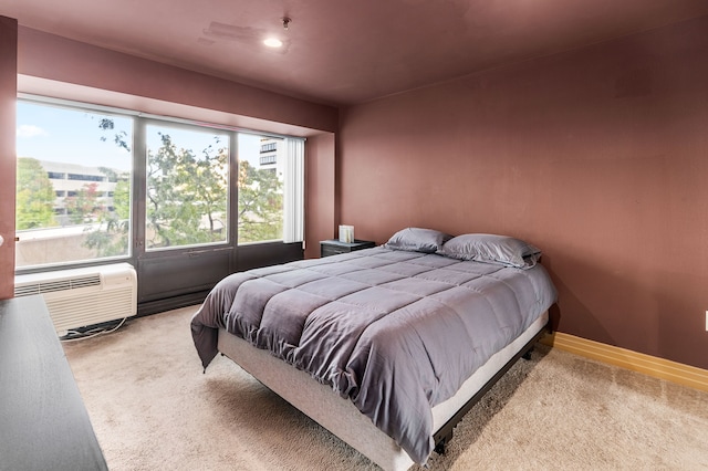 carpeted bedroom featuring a wall mounted AC