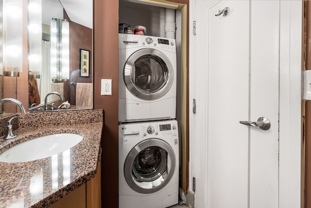 washroom with stacked washer and clothes dryer and sink