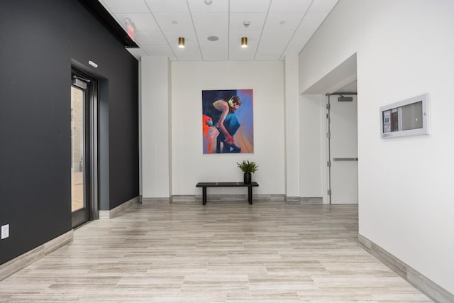 hallway featuring a paneled ceiling