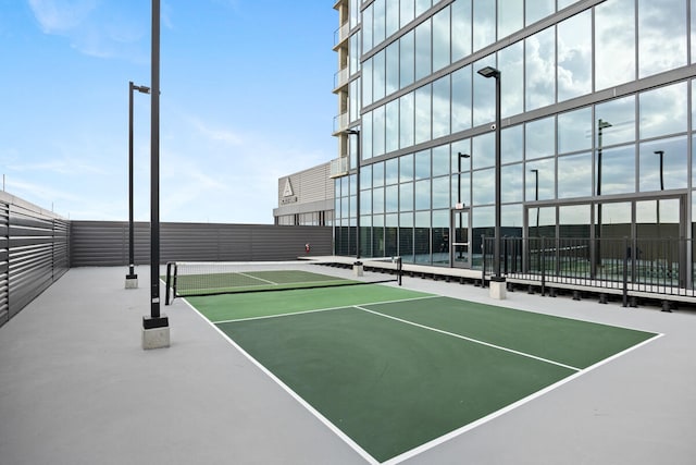 view of tennis court featuring basketball hoop