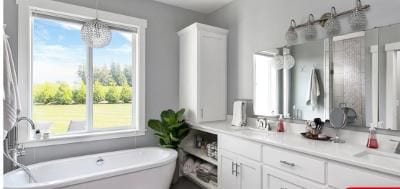 bathroom featuring a tub to relax in, vanity, and a notable chandelier