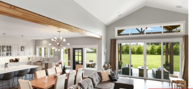 living room featuring a chandelier and high vaulted ceiling