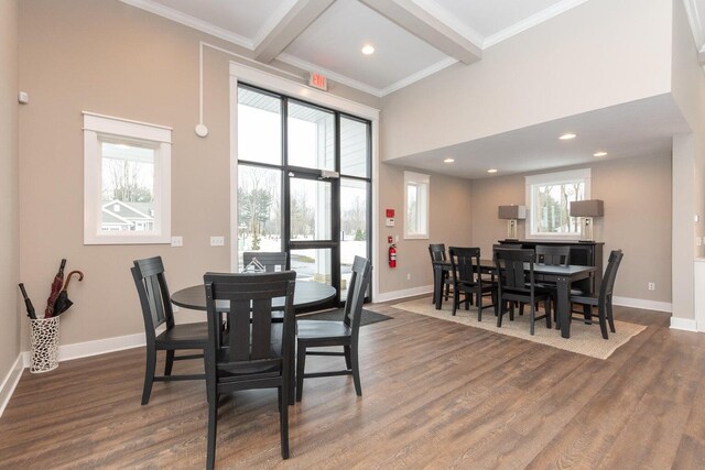 dining area with beamed ceiling and dark hardwood / wood-style floors