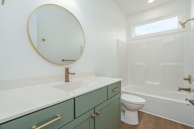 full bathroom featuring wood-type flooring,  shower combination, vanity, and toilet