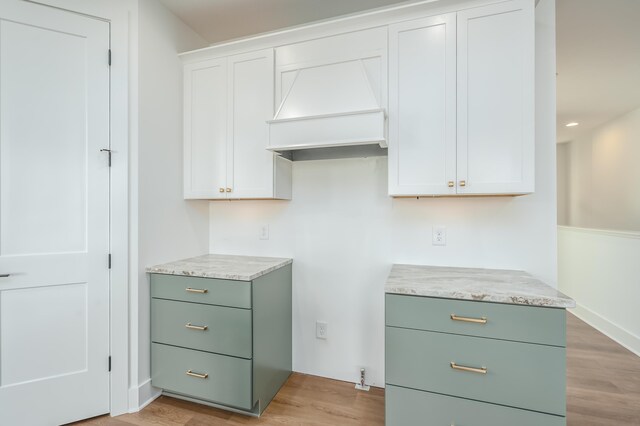 kitchen featuring white cabinets and light wood-type flooring