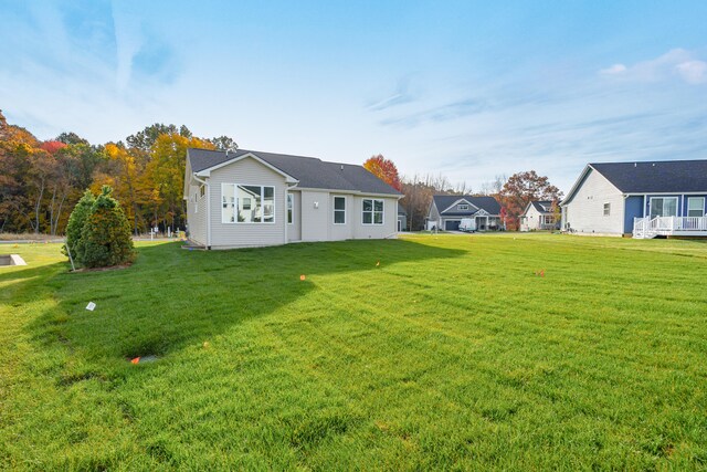 rear view of property with a yard