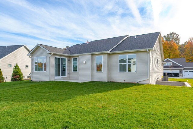 rear view of property with a yard and a patio area