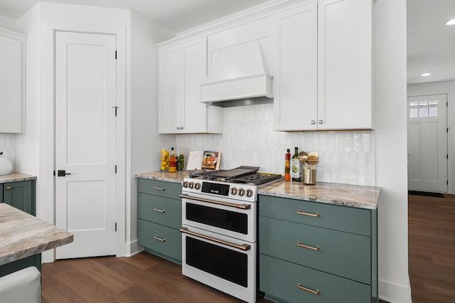 kitchen featuring double oven range, dark hardwood / wood-style floors, custom range hood, and white cabinets