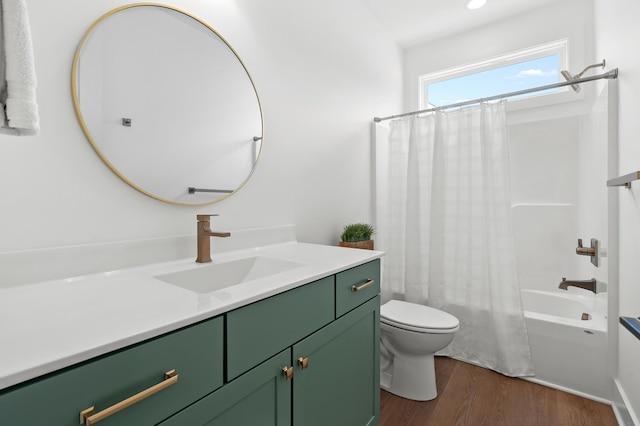 full bathroom featuring vanity, hardwood / wood-style floors, shower / bath combination with curtain, and toilet